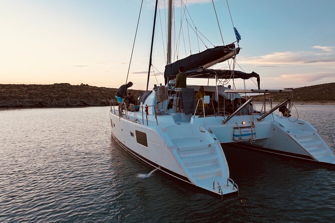 Private Mykonos Catamaran Day Cruise with Meals & Water Toys - Stop 3: Rineia for clearer water and calmer anchoring